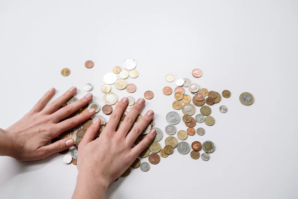 Image of a person arranging coins to denote fintech in logistics