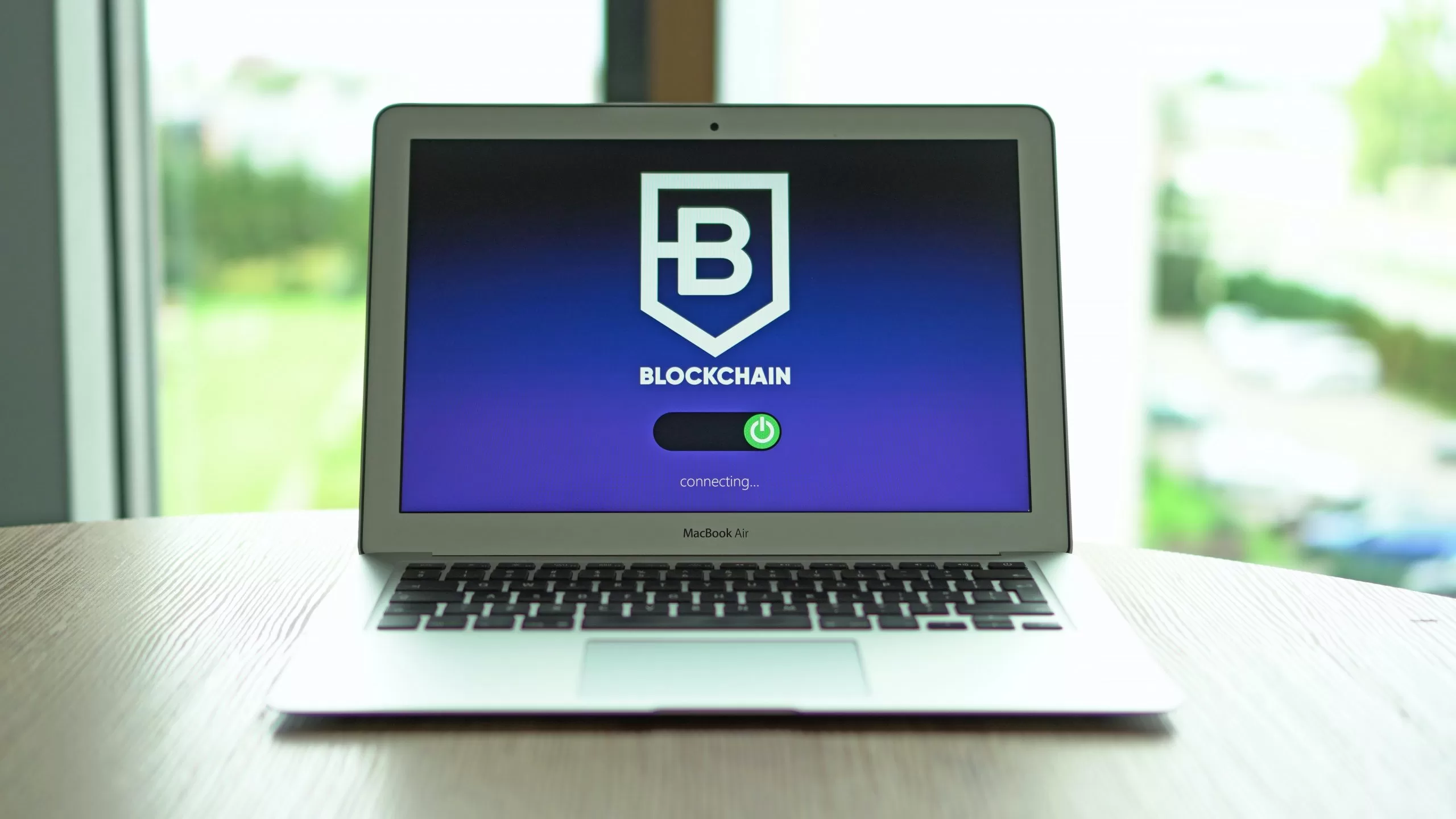 Image of a laptop showing the word "Blockchain" to denote blockchain in logistics
