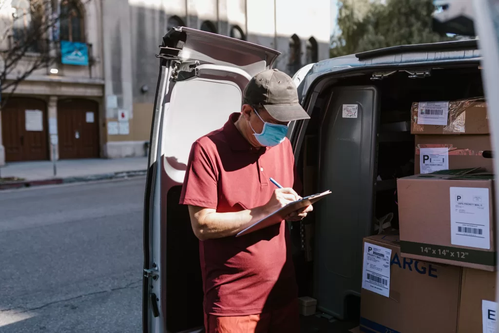 Image of a person taking inventory of packages to denote challenges in transportation and logistics