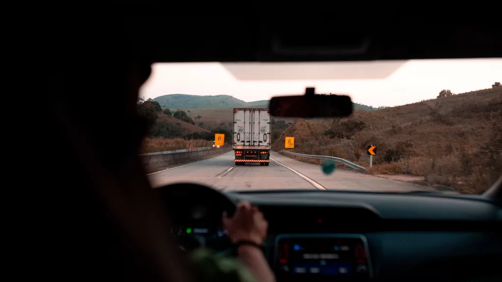 Image of a person driving a truck to denote an online truck booking platform