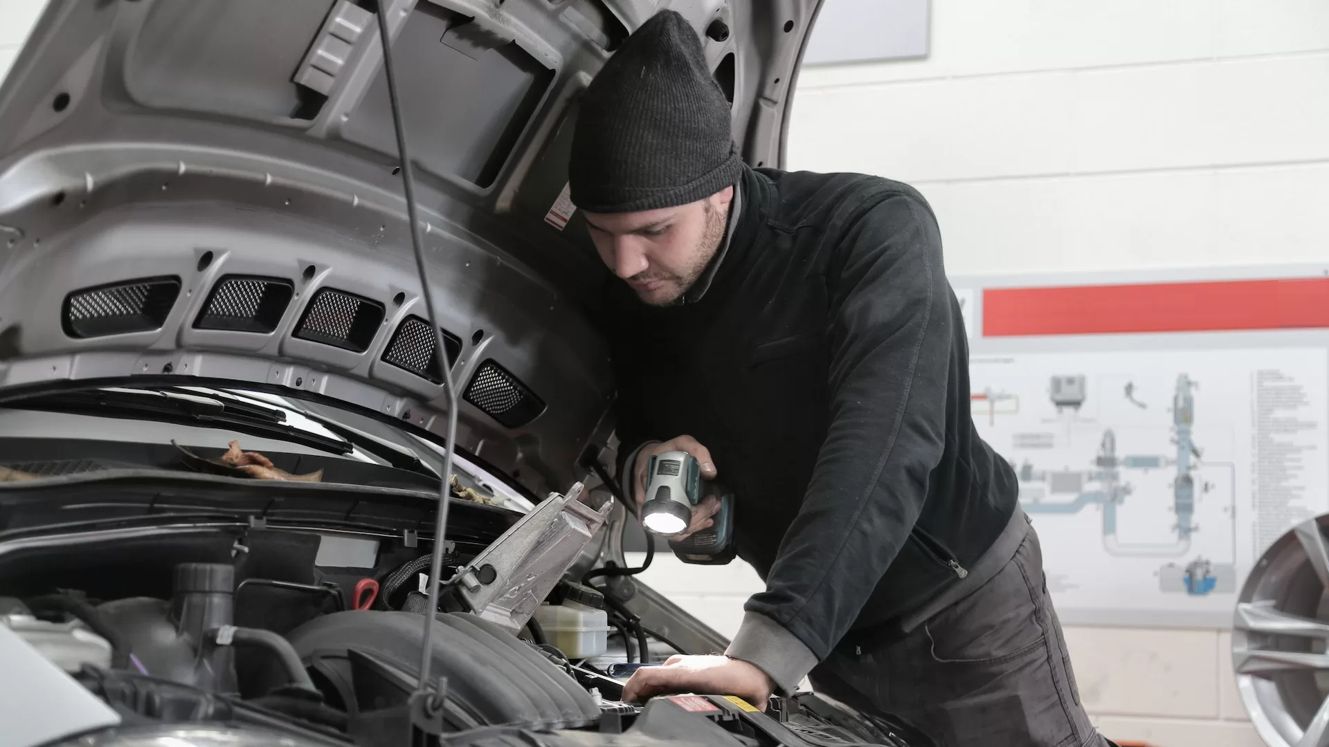 Image of a person inspecting a truck to denote truck spare parts