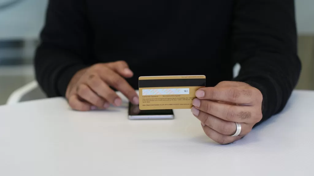 Image of a person using a debit card to denote prepaid fleet cards