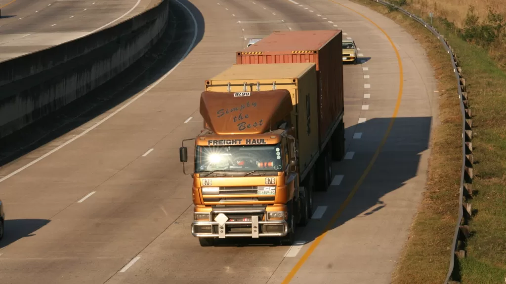 Image of a truck on a highway to denote FASTag for commercial vehicles